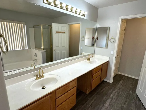 a bathroom with a double vanity sink and a mirror