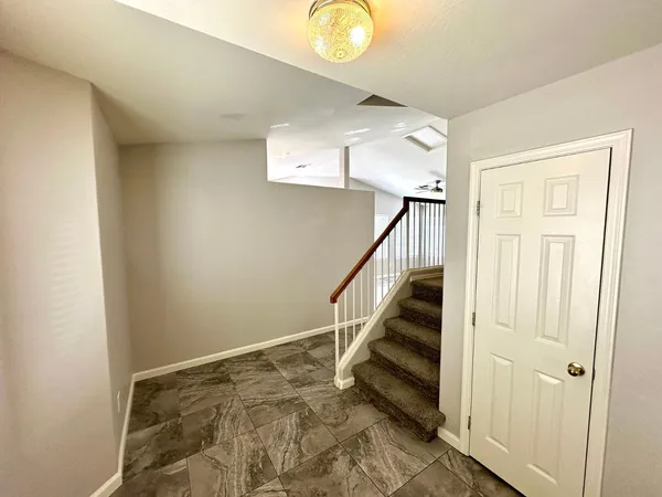 a view of entryway with stairs and wooden floor