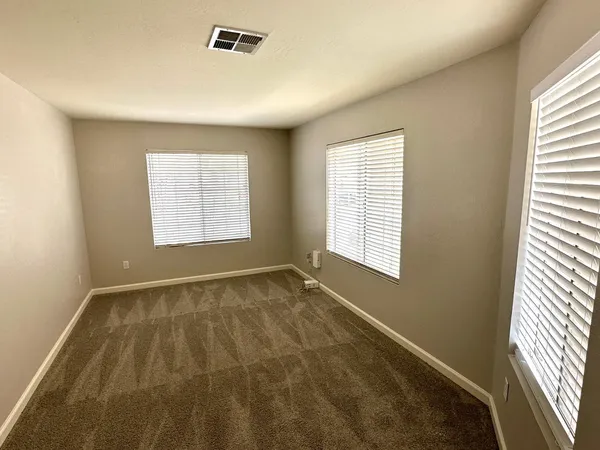 a view of an empty room and a window
