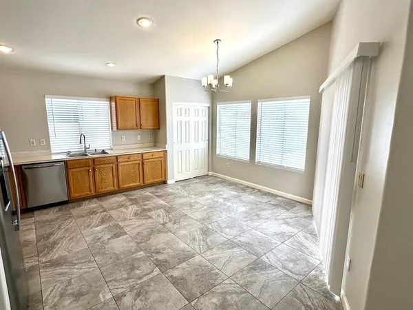 a large kitchen with cabinets and wooden floor