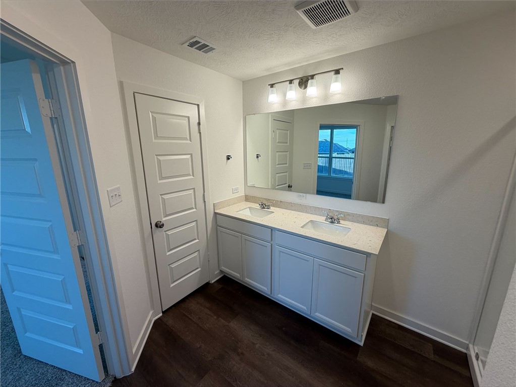 222 Cross Lane Caldwell, TX 77836 - Photo 11 of 13 a bathroom with a double vanity sink and mirror