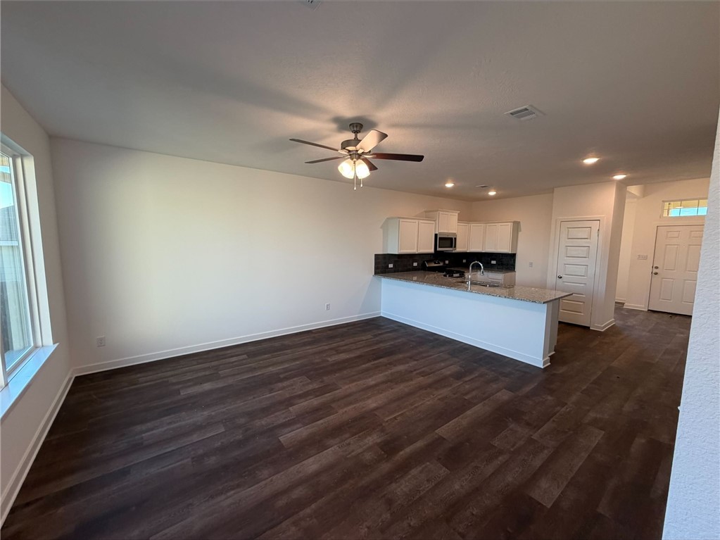 222 Cross Lane Caldwell, TX 77836 - Photo 13 of 13 a kitchen with granite countertop a stove and a wooden floor