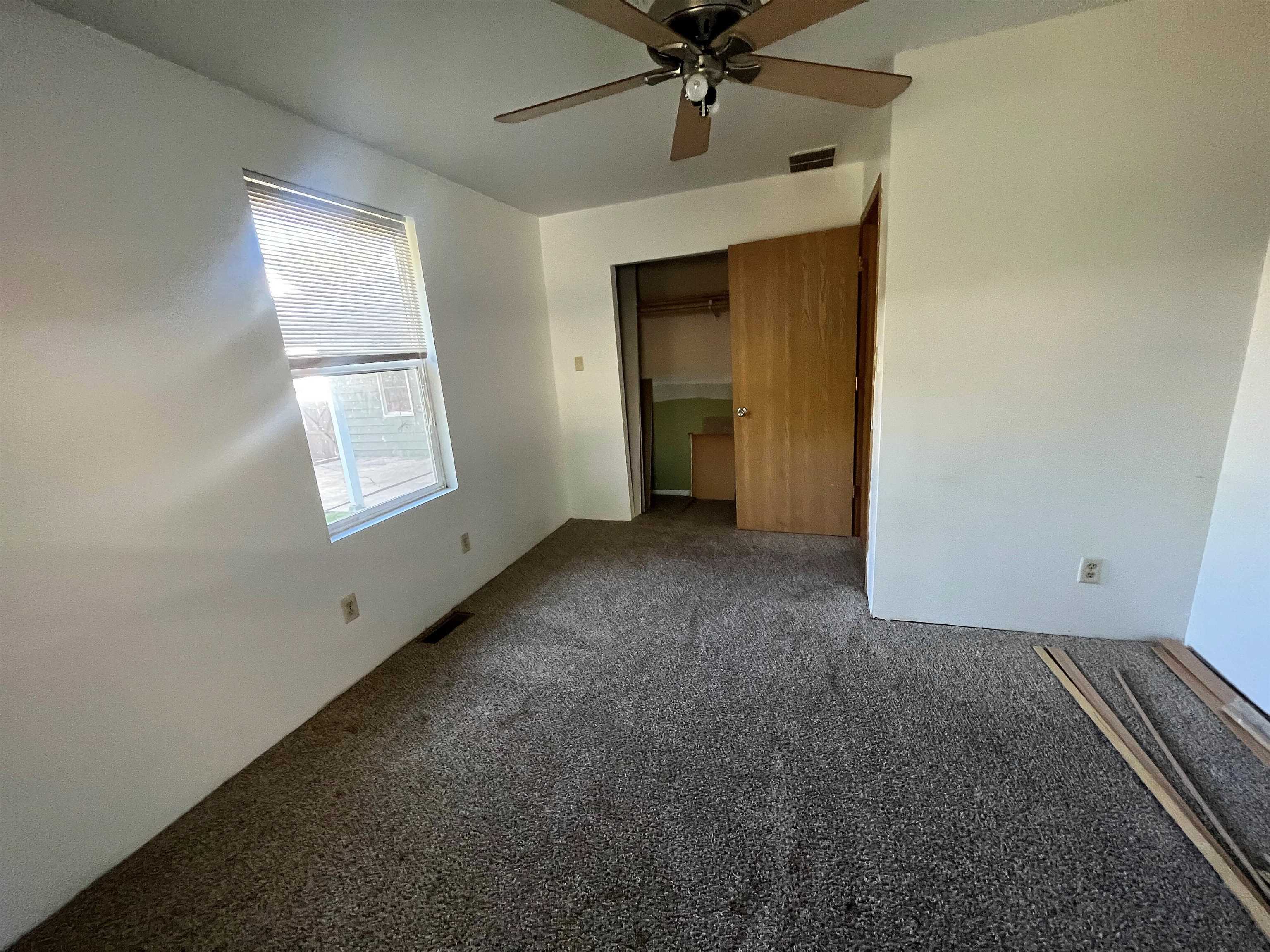4026 Pinecrest Road Rockford, IL 61107 - Photo 14 of 27 an empty room with a ceiling fan and a window