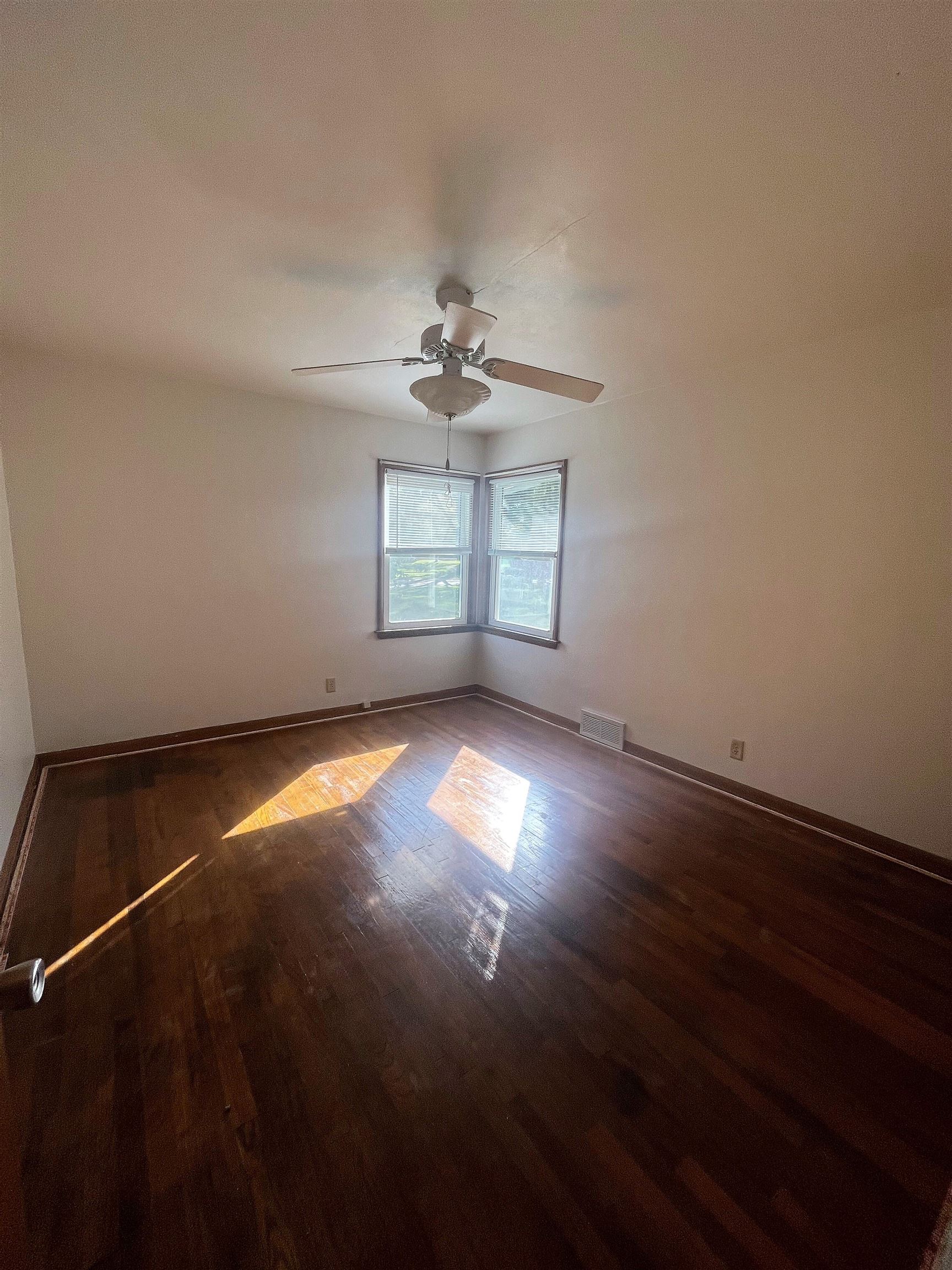 4026 Pinecrest Road Rockford, IL 61107 - Photo 19 of 27 an empty room with a window and wooden floor