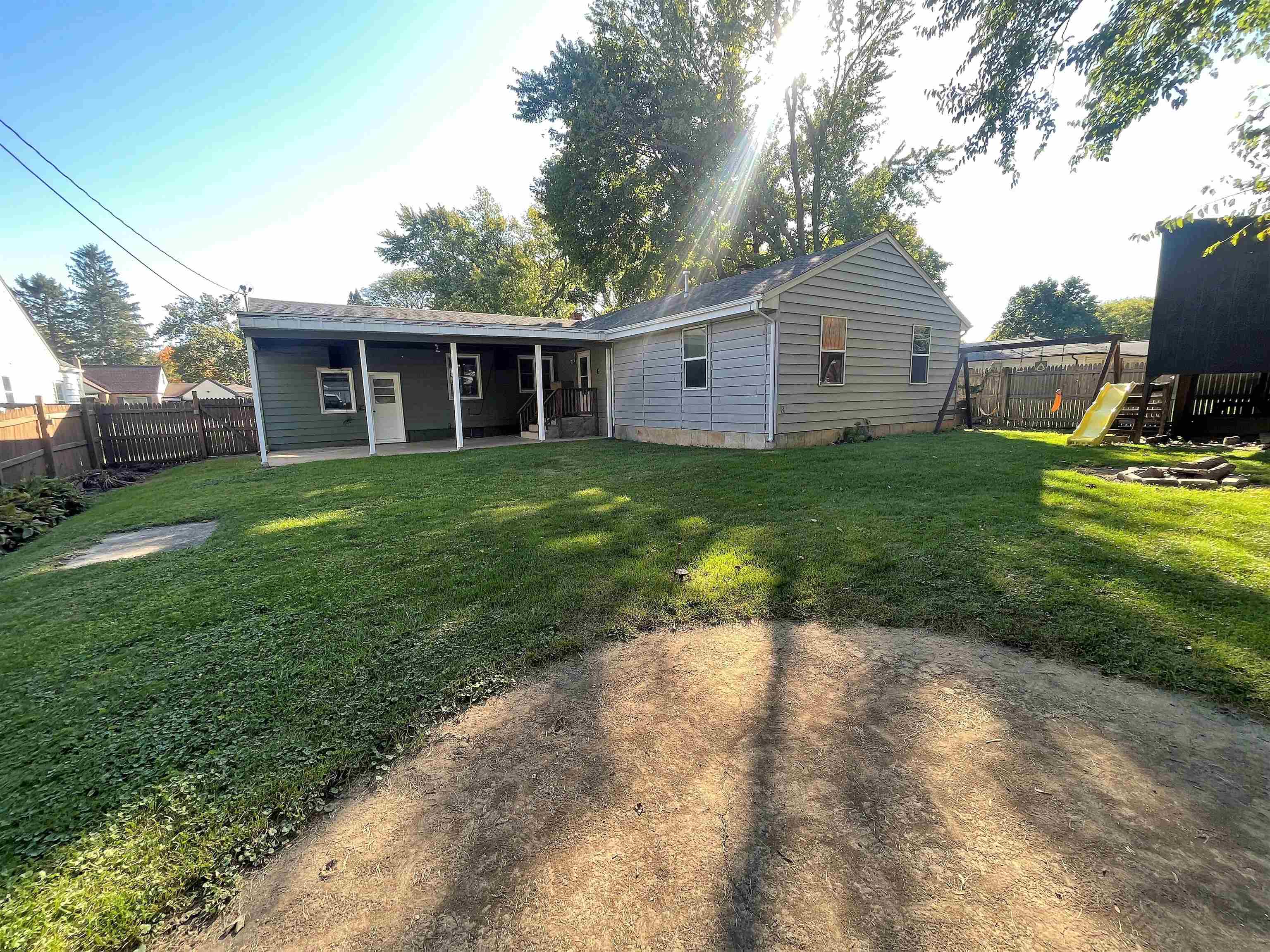 4026 Pinecrest Road Rockford, IL 61107 - Photo 24 of 27 a view of a backyard with plants and large trees