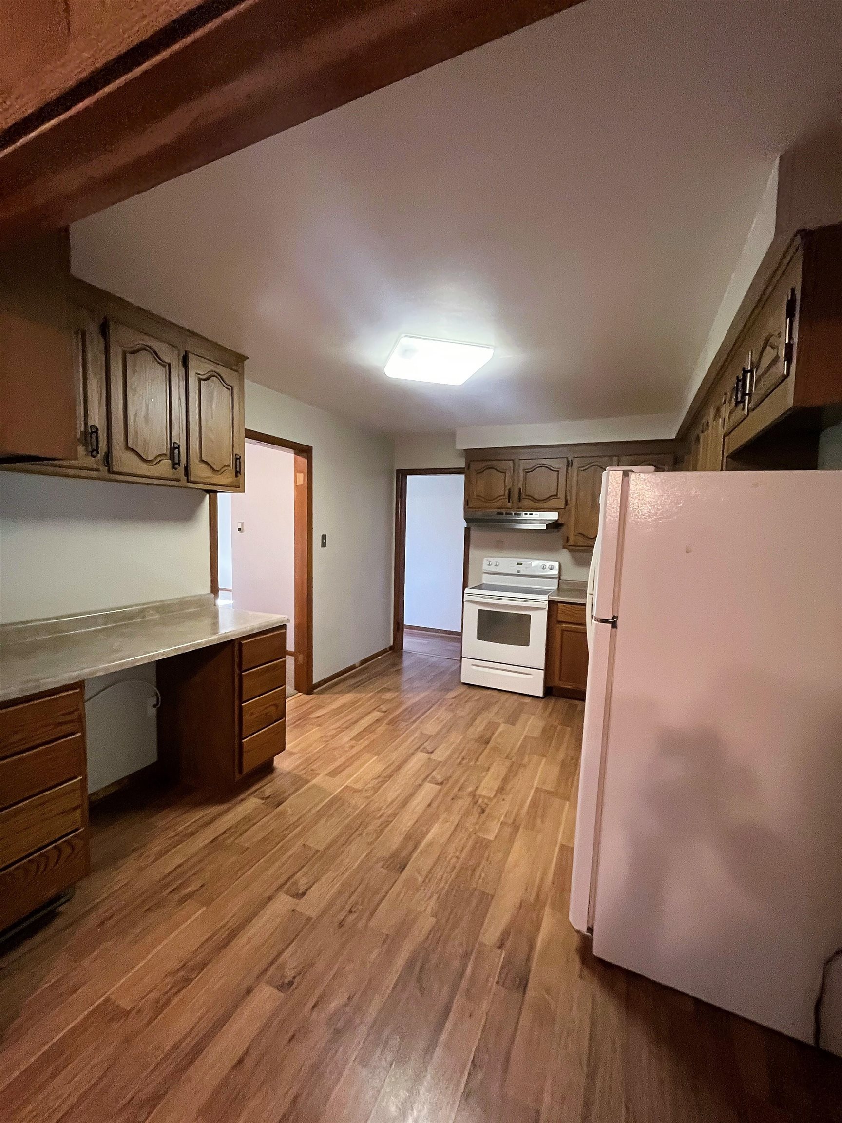 4026 Pinecrest Road Rockford, IL 61107 - Photo 6 of 27 a kitchen with granite countertop a refrigerator and a stove top oven