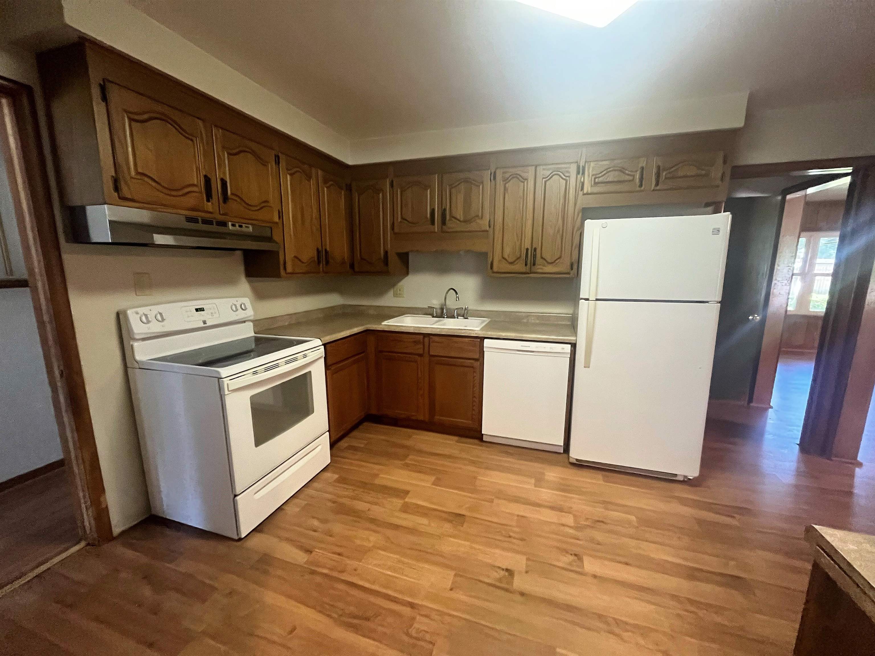 4026 Pinecrest Road Rockford, IL 61107 - Photo 7 of 27 a kitchen with wooden cabinets and white appliances