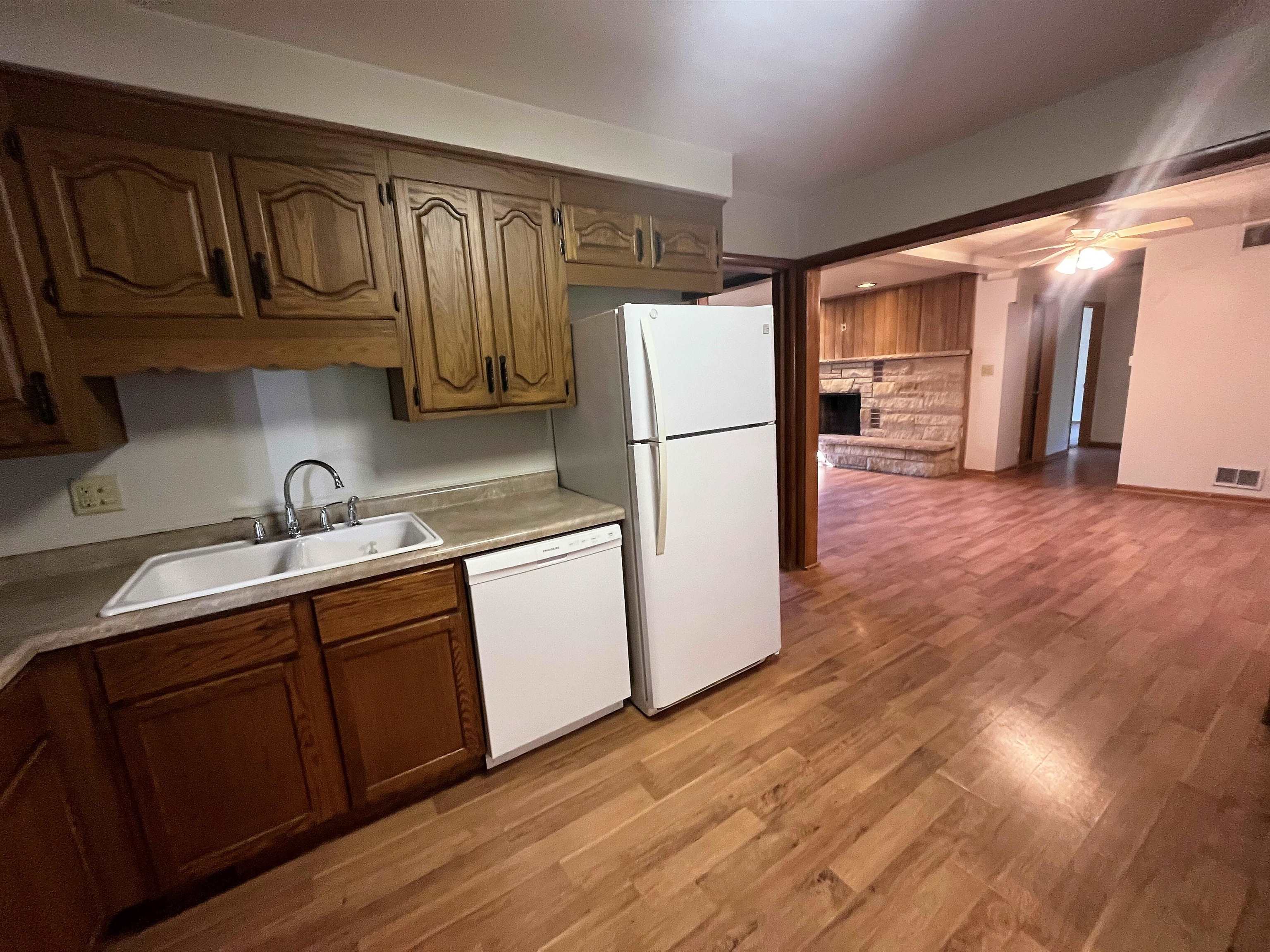 4026 Pinecrest Road Rockford, IL 61107 - Photo 8 of 27 a kitchen with sink a refrigerator and cabinets