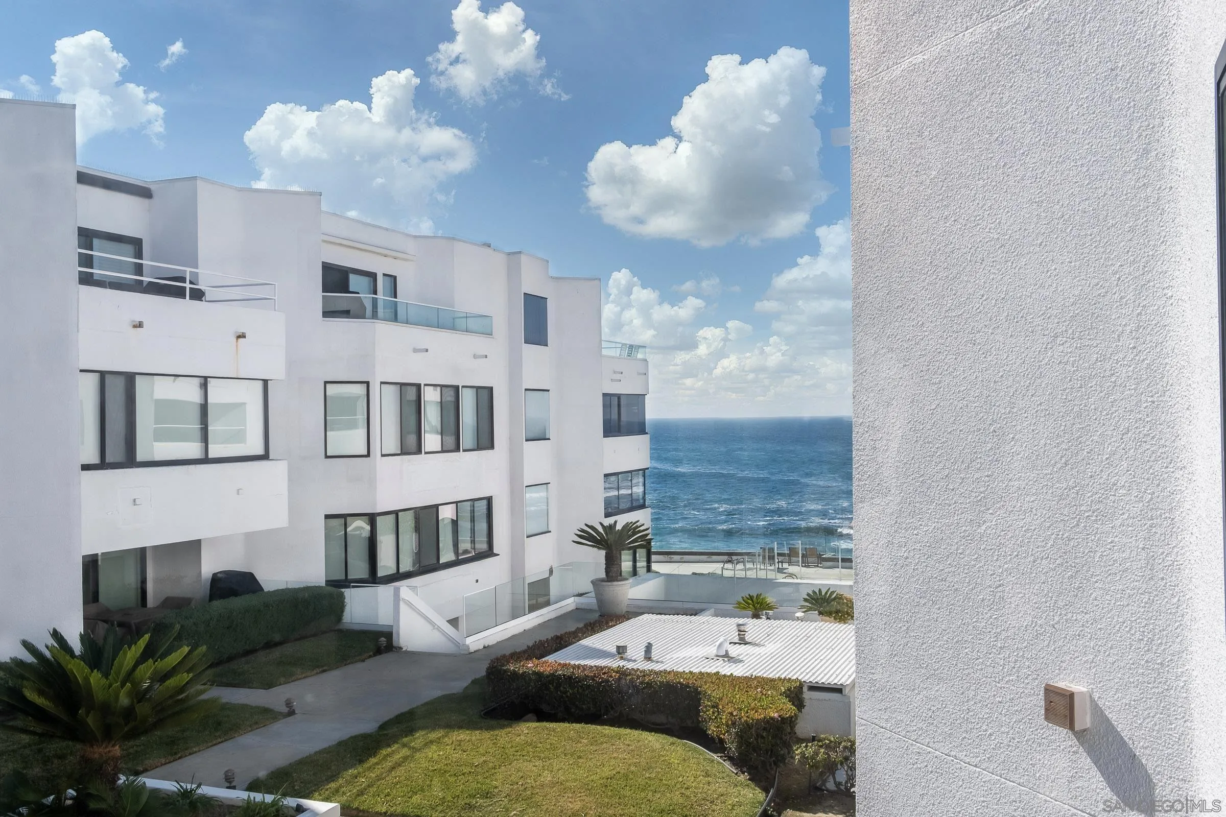 100 Coast Boulevard, Unit 308 La Jolla, CA 92037 - Photo 32 of 40 a living room with furniture flowers and a chandelier