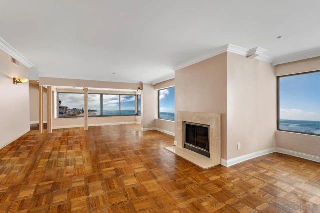 a view of an empty room with a fireplace and a window