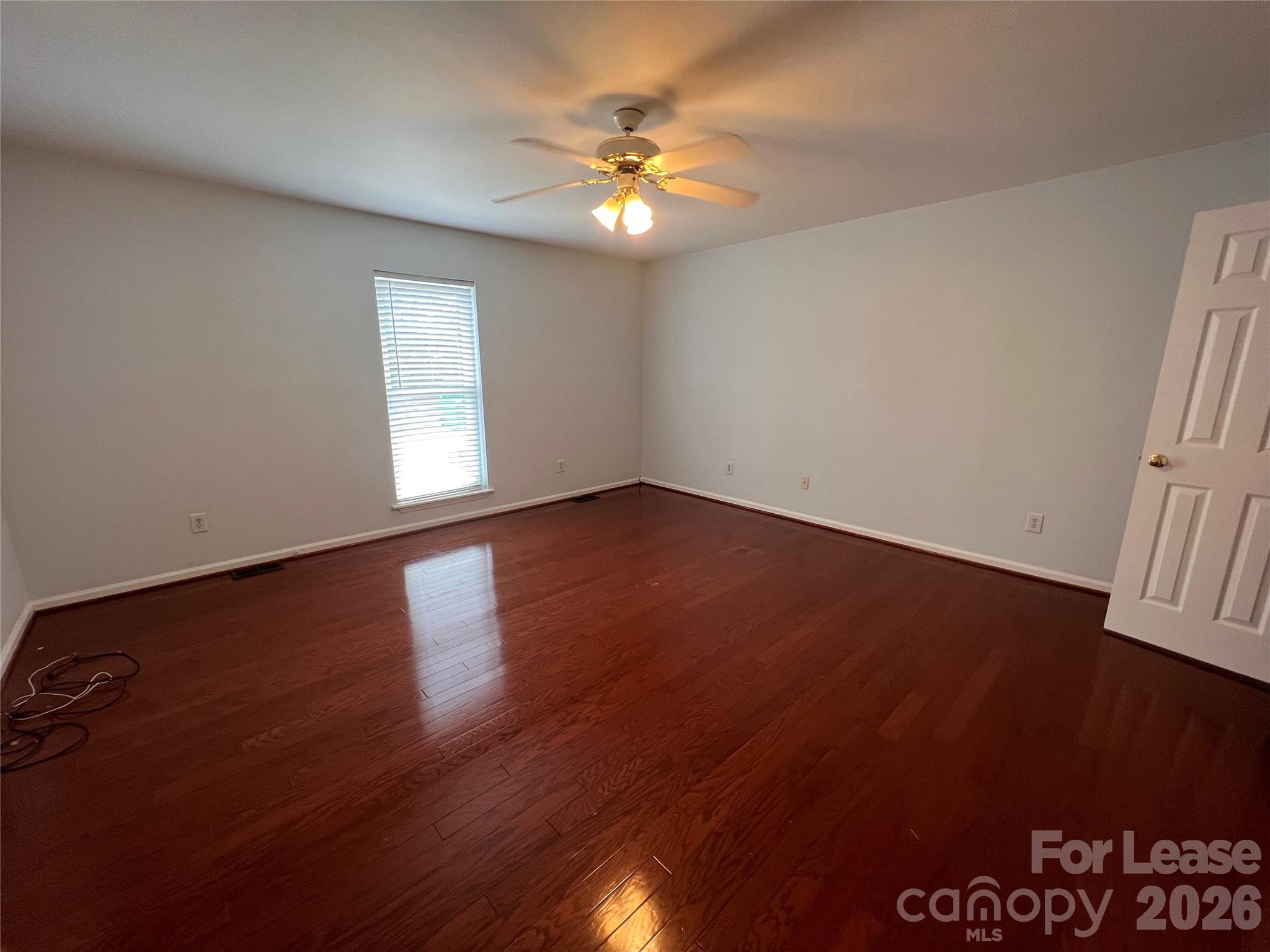5312 Rea Road Charlotte, NC 28226 - Photo 12 of 34 an empty room with wooden floor and windows