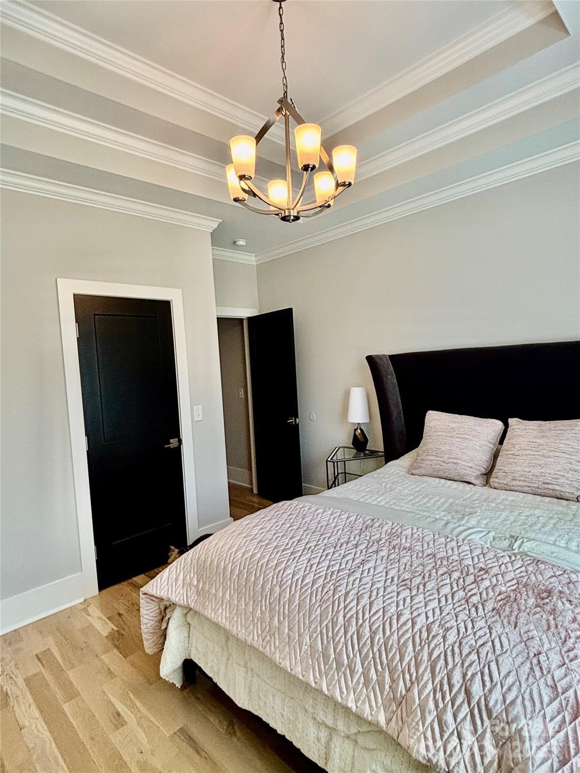 108 41st Avenue Northwest Hickory, NC 28601 - Photo 26 of 48 a bedroom with a bed and a chandelier