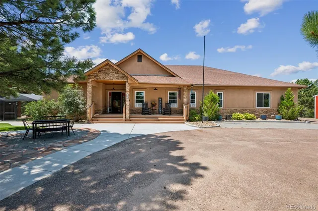 a front view of a house with a garden and plants