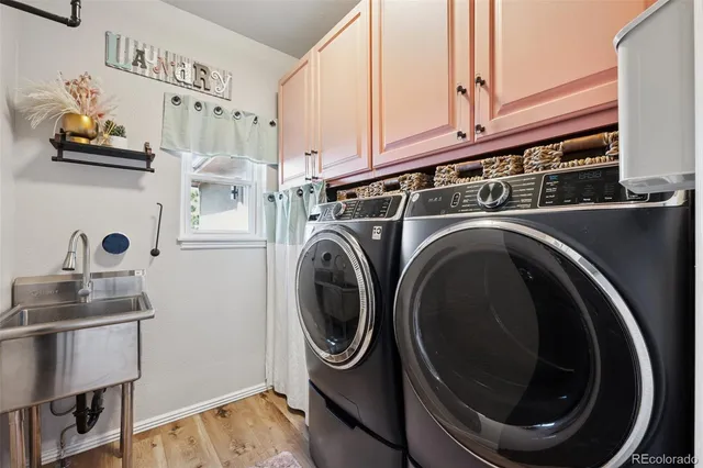 a utility room with sink dryer and washer