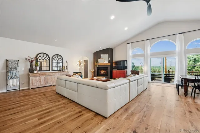 a living room with furniture fireplace and dining table