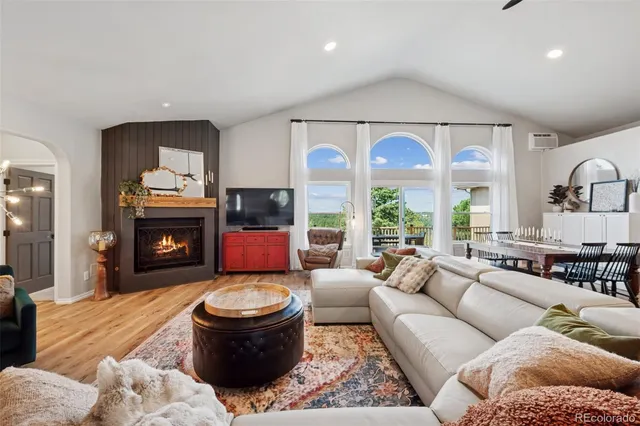 a living room with furniture a window and a fireplace