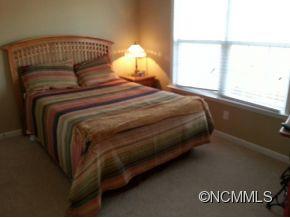 182 Pamlico Road Fletcher, NC 28732 - Photo 8 of 11 a bedroom with a bed and a window