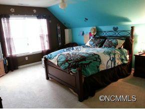 182 Pamlico Road Fletcher, NC 28732 - Photo 9 of 11 a bed sitting in a bedroom next to a window
