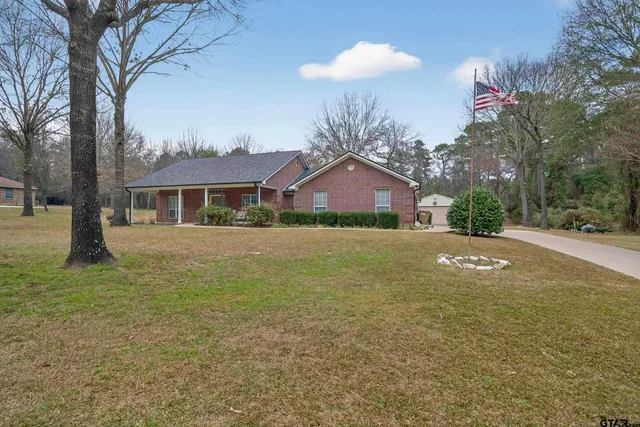 a view of house with yard