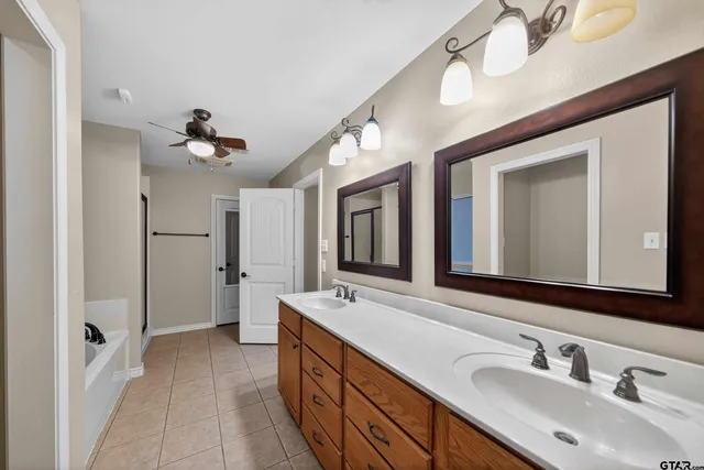 a spacious bathroom with a double vanity sink mirror and