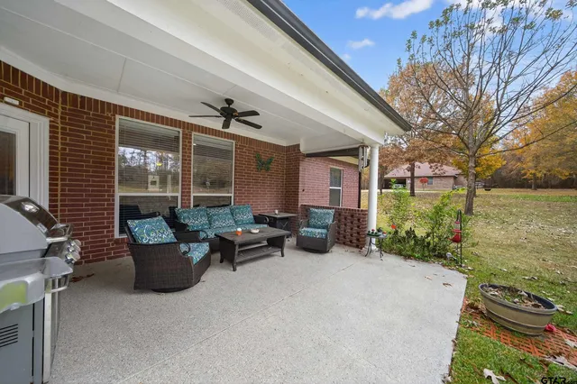 a balcony with furniture and a potted plant