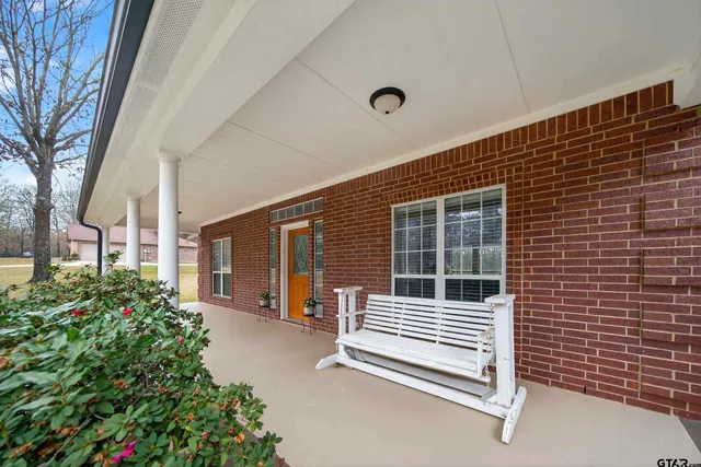 a view of a patio with a table and chairs and potted plants