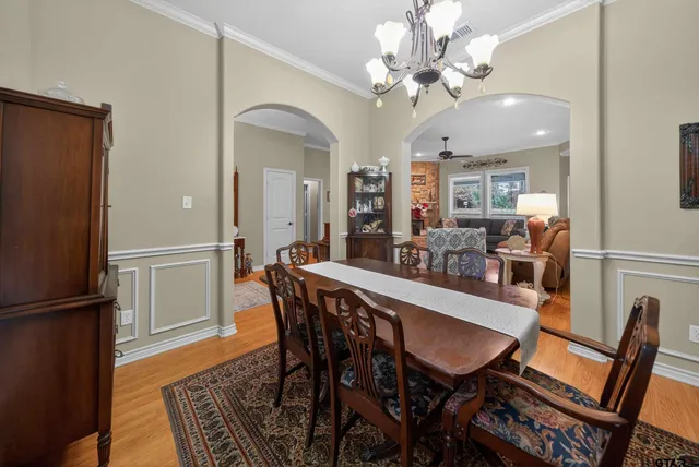 a view of a dining room with furniture and a chandelier