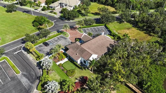 an aerial view of residential houses with outdoor space and trees