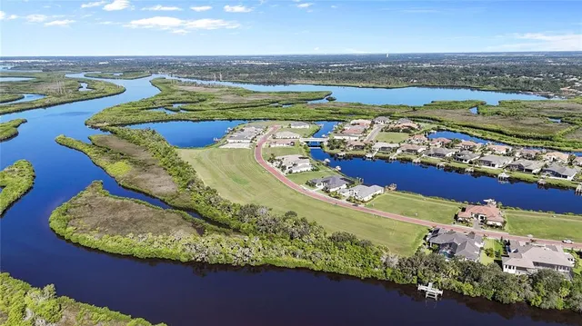 an aerial view of a residential houses outdoor space and swimming pool