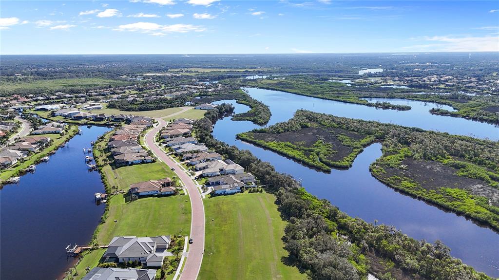 1632 Rio Vista Terrace Parrish, FL 34219 - Photo 10 of 34 an aerial view of a city with lots of residential buildings ocean and mountain view in back