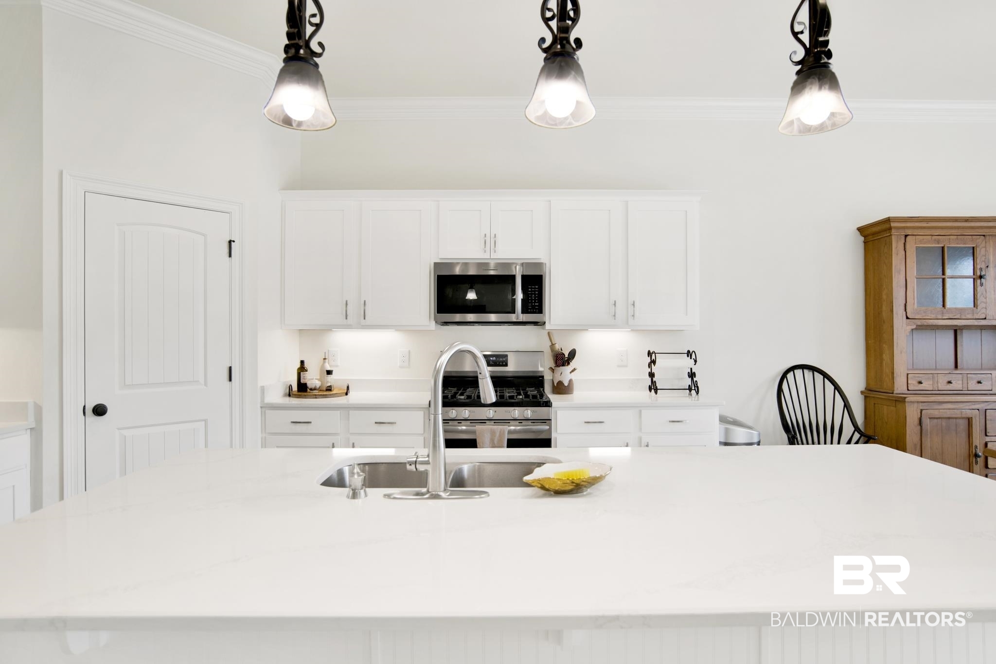 22258 Hibiscus Circle Foley, AL 36535 - Photo 7 of 26 Kitchen with a sink, decorative light fixtures, ornamental molding, and stainless steel appliances