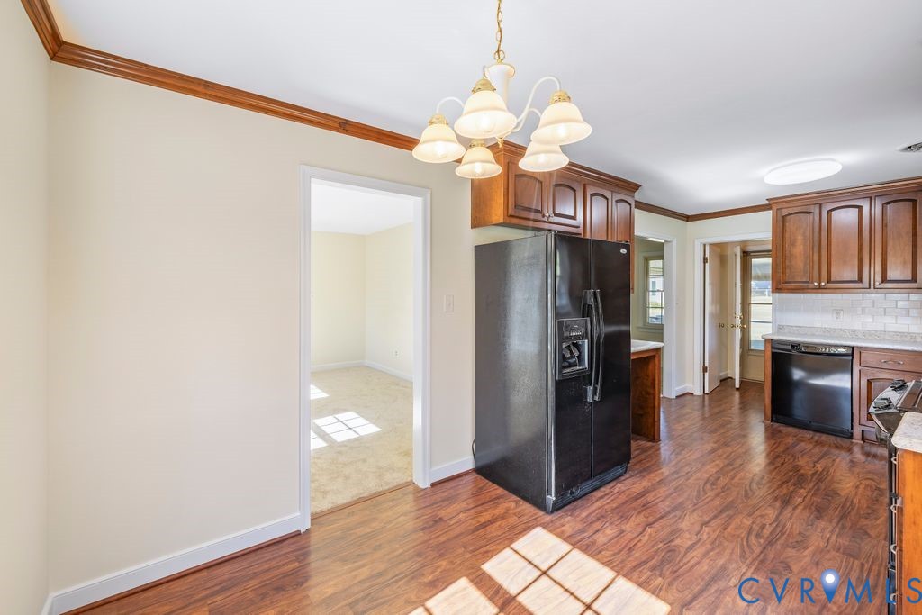 11210 Celtic Road Chesterfield, VA 23838 - Photo 8 of 39 a view of a kitchen with wooden floor and a refrigerator