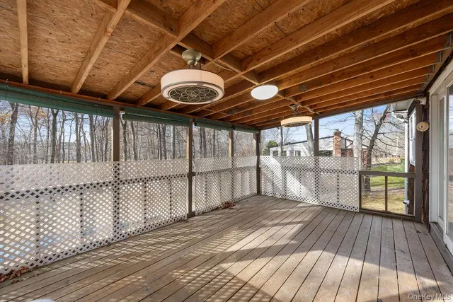 a view of a porch with wooden floor