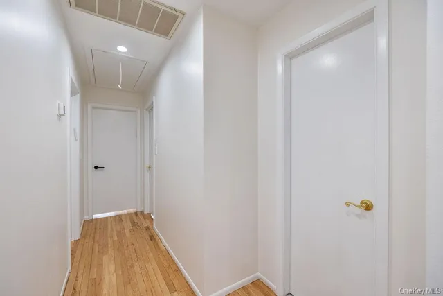 a view of hallway with wooden floor