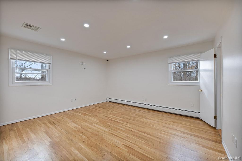 9 New Ackertown Road Monsey, NY 10952 - Photo 16 of 37 a view of an empty room with wooden floor and a window