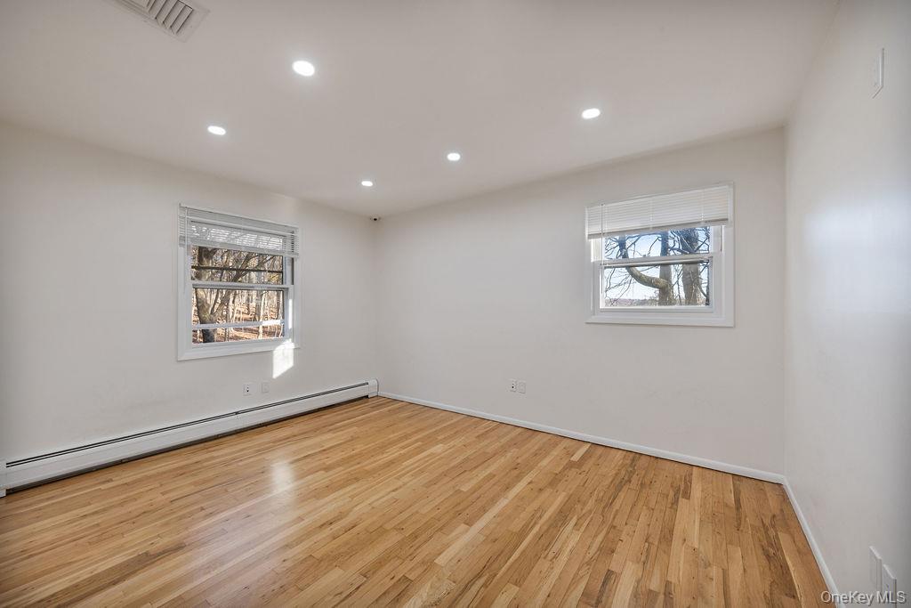 9 New Ackertown Road Monsey, NY 10952 - Photo 21 of 37 a view of empty room with wooden floor and fan