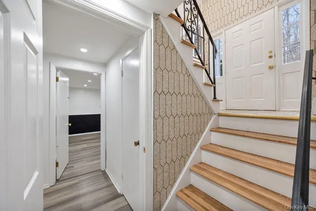 a view of a hallway with wooden floor and entryway
