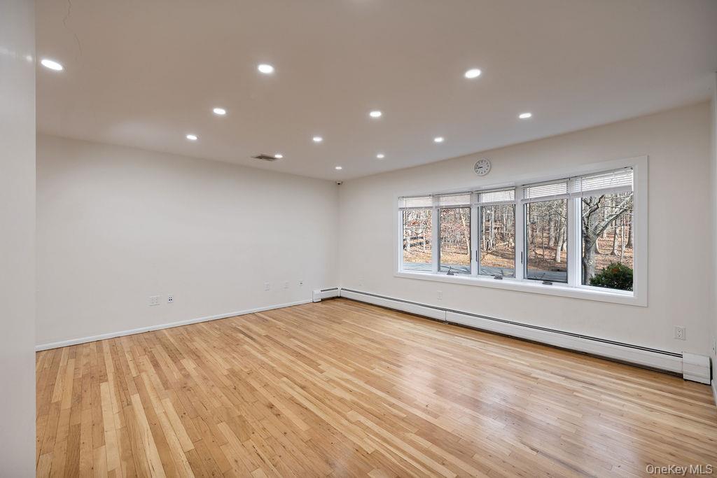 9 New Ackertown Road Monsey, NY 10952 - Photo 5 of 37 a view of an empty room with wooden floor and a window