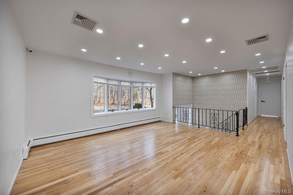 9 New Ackertown Road Monsey, NY 10952 - Photo 6 of 37 a view of an empty room with wooden floor and a window