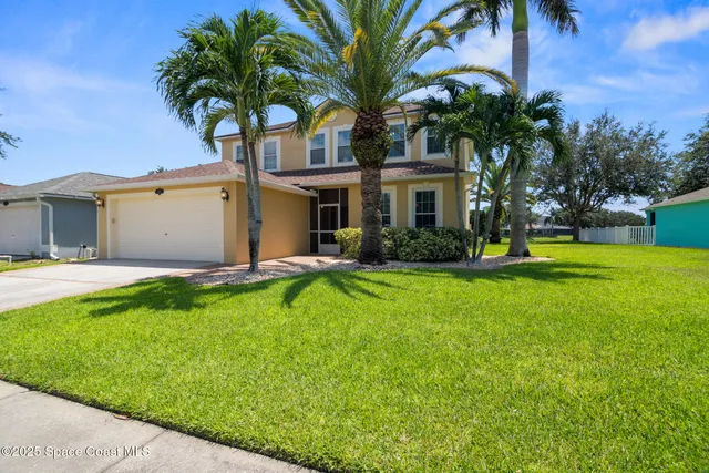 a front view of house with yard and green space