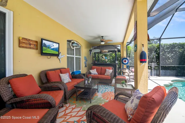 a outdoor living space with furniture and a flat screen tv