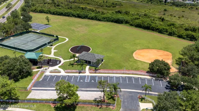 an aerial view of a house with swimming pool and outdoor seating