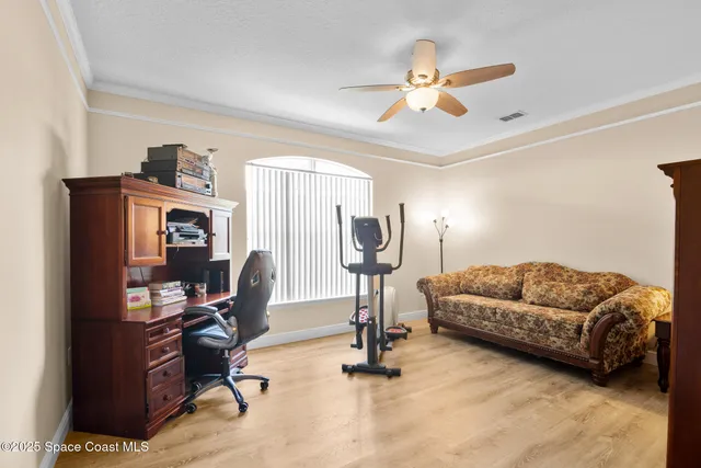a living room with furniture and a gym equipment