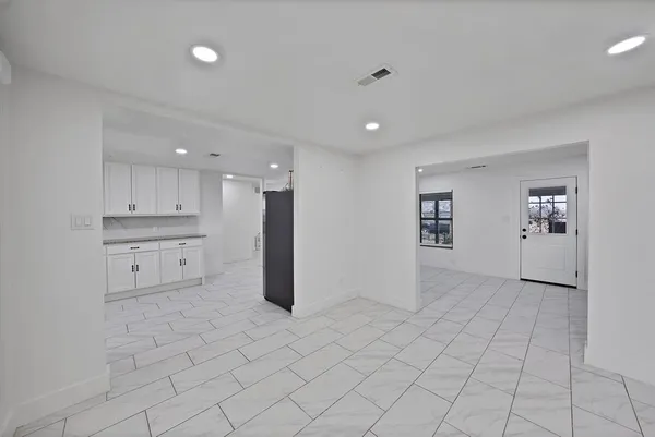 a view of kitchen with white cabinets