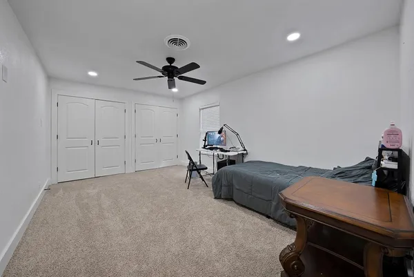 a living room with furniture and a ceiling fan