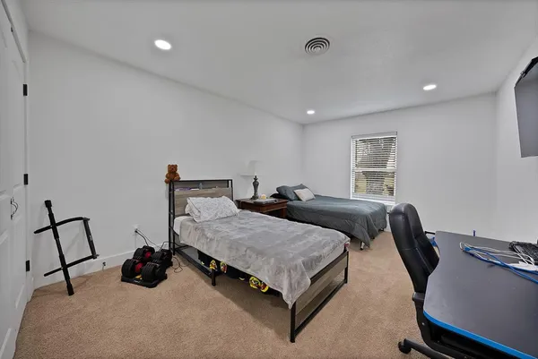 a bedroom with bed and a window