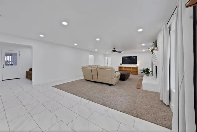 a kitchen with stainless steel appliances kitchen island granite countertop a refrigerator and a stove top oven