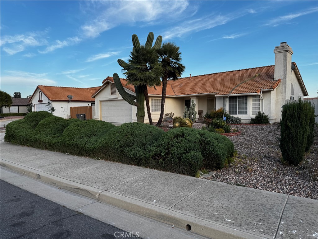 27519 Terrytown Road Menifee, CA 92586 - Photo 3 of 22 a white house with a yard and plants
