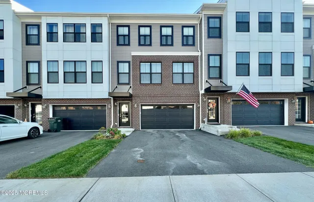 a front view of a building with a garden