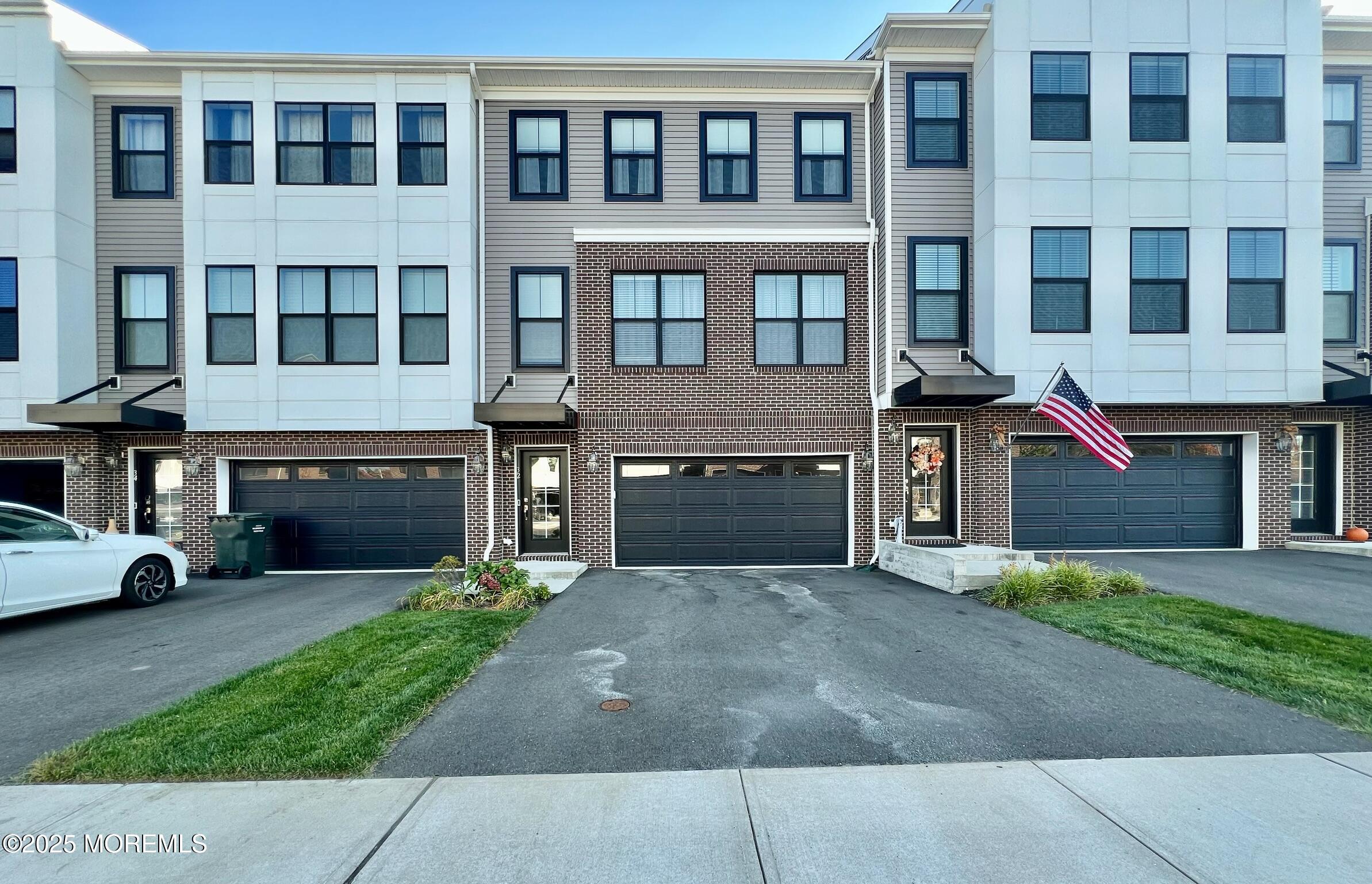 32 Mariveles Way Tinton Falls, NJ 07724 - Photo 1 of 28 a front view of a building with a garden